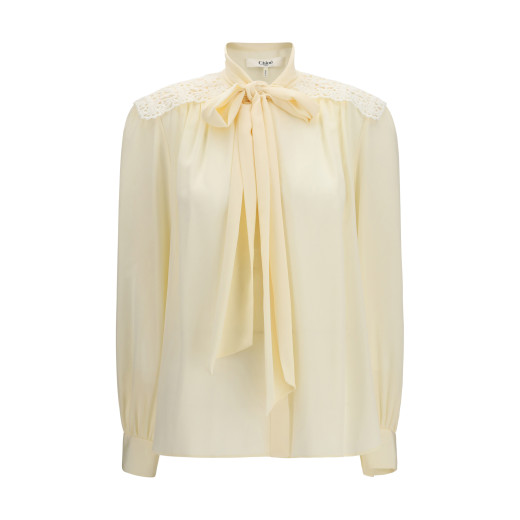 어깨 부분에 자수 장식이 있는 리본 블라우스